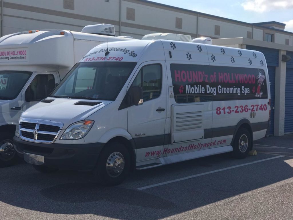 Mobile dog grooming van parked outside