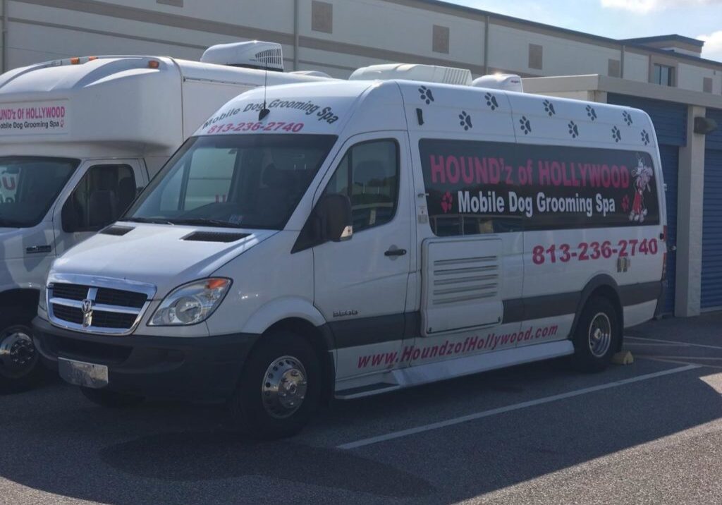Mobile dog grooming van parked outside